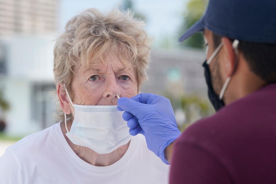 Georgina Catling, 75, gets tested for COVID-19 on Thursday, Sept. 9, 2021, in Miami. President Joe Biden is toughening COVID-19 vaccine requirements for federal workers and contractors as he aims to boost vaccinations and curb the surging delta variant that is killing thousands each week and jeopardizing the nation's economic recovery. (AP Photo/Marta Lavandier)