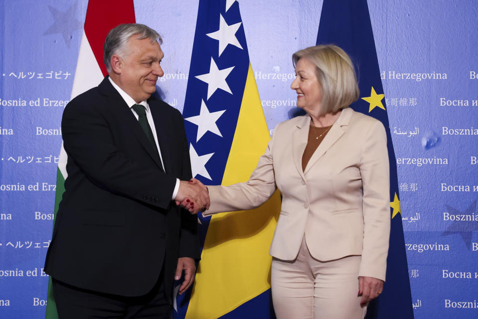 Hungarian Prime Minister Viktor Orban, left, shakes hands with the President of the Council of Ministers of Bosnia and Herzegovina Borjana Kristo prior to their meeting in Sarajevo, Bosnia, Thursday, April 4, 2024. (AP Photo)