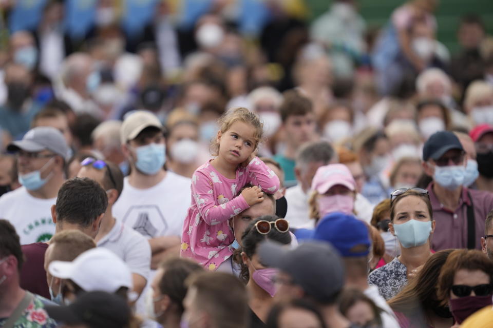 People wait for Pope Francis at Lokomotiva Stadium in Košice, Slovakia, Tuesday, Sept. 14, 2021. Francis first trip since undergoing intestinal surgery in July, marks the restart of his globetrotting papacy after a nearly two-year coronavirus hiatus. (AP Photo/Darko Vojinovic)