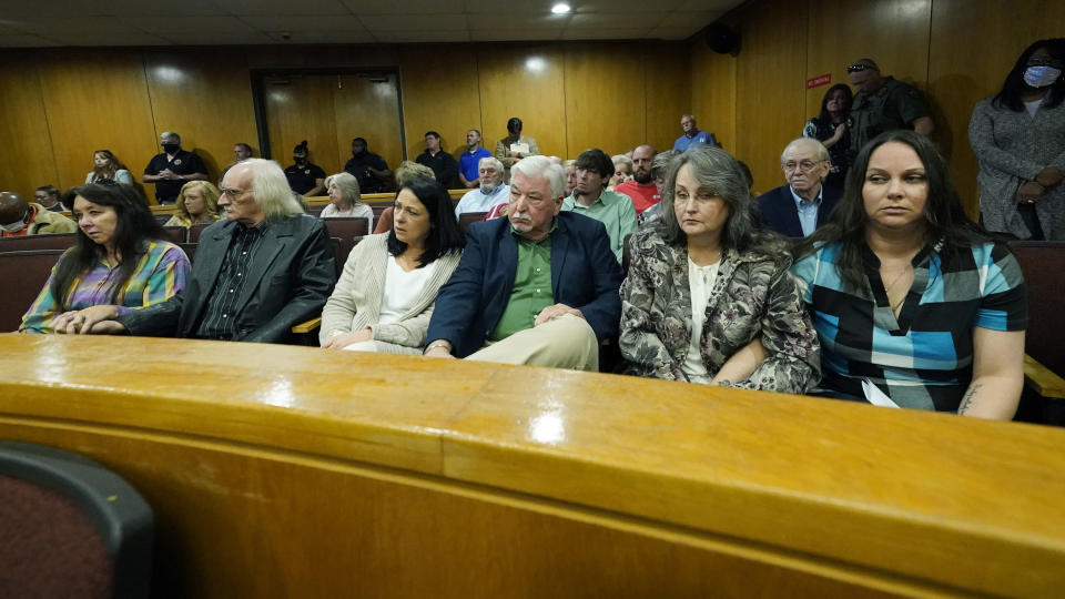 Family members of the two Brookhaven police officers murdered in 2018 by admitted killer, Marquis Aaron Flowers, 28, unseen, listen grimly as he addresses them after pleading guilty to first degree murder in their deaths, in Brookhaven, Miss., Wednesday, Nov. 3, 2031. (AP Photo/Rogelio V. Solis)