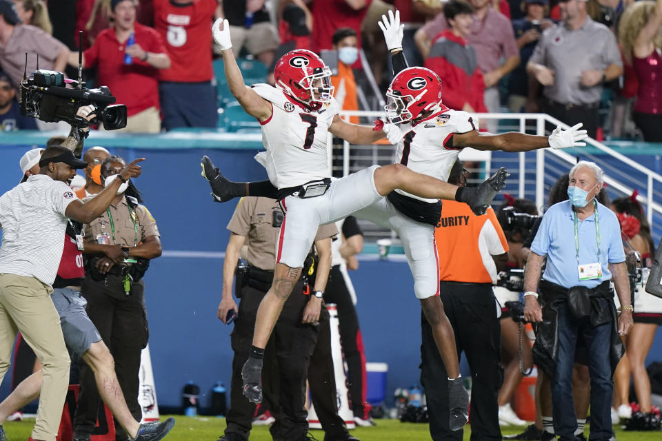 Georgia wide receiver Jermaine Burton celebrates after scoring with wide receiver George Pickens against Michigan during the first half of the Orange Bowl NCAA College Football Playoff semifinal game, Friday, Dec. 31, 2021, in Miami Gardens, Fla.(AP Photo/Lynne Sladky)