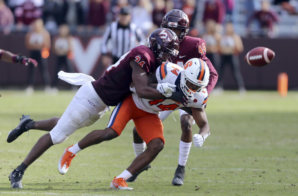 FILE - Virginia Tech linebacker Alan Tisdale (34) breaks up a pass intended for Syracuse's Anthony Queeley (14) during the second half of an NCAA college football game in Blacksburg Va., Saturday, Oct. 23 2021. Virginia Tech opens their season at home against Old Dominion on Sept. 2.(Matt Gentry/The Roanoke Times via AP, File)