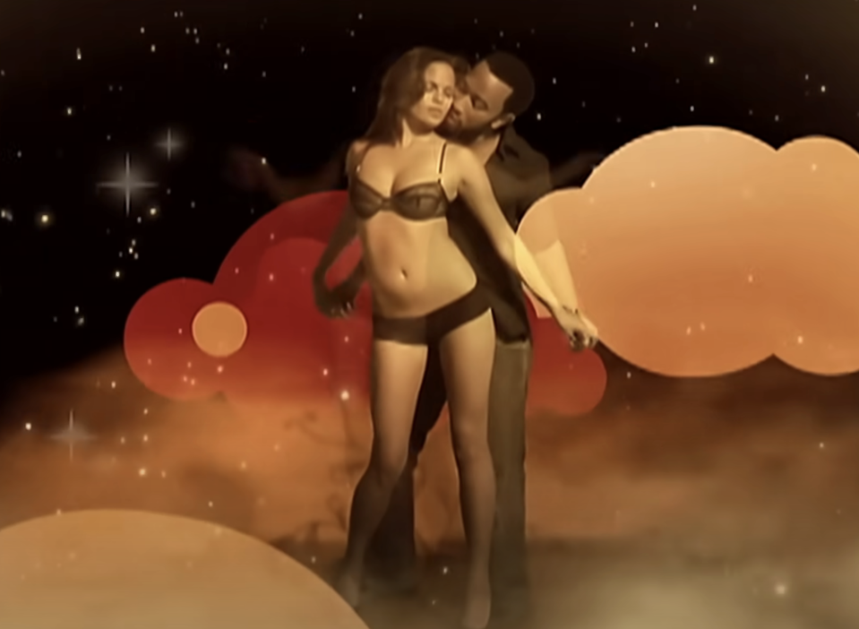 the couple embracing, Chrissy in lingerie, John in pants, with a whimsical cosmic backdrop