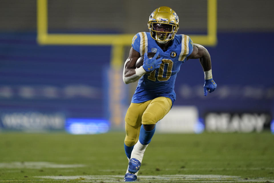 CORRECTS TO UCLA RUNNING BACK DEMETRIC FELTON NOT SOUTHERN CALIFORNIA QUARTERBACK MO HASAN - UCLA running back Demetric Felton runs to the end zone for a touchdown during the second quarter of an NCAA college football game against Southern California, Saturday, Dec 12, 2020, in Pasadena, Calif. (AP Photo/Ashley Landis)