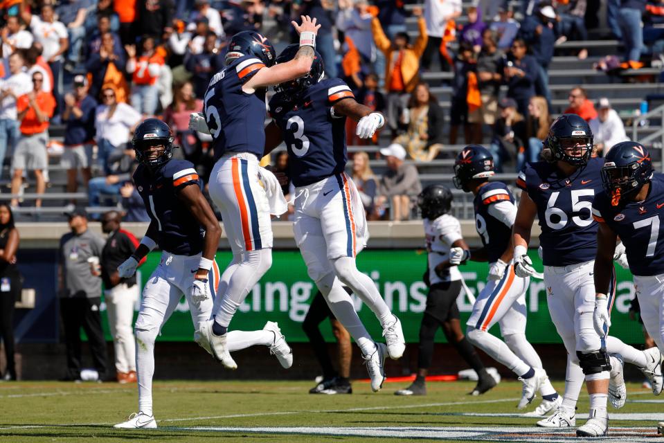 Oct 8, 2022; Charlottesville, Virginia, USA; Virginia Cavaliers quarterback Brennan Armstrong (5) celebrates with Cavaliers wide receiver Dontayvion Wicks (3) after connecting on a touchdown pass against the Louisville Cardinals during the first quarter at Scott Stadium. Mandatory Credit: Geoff Burke-USA TODAY Sports