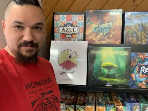 Co-owner David Plamondon with some games on display, including the Inuit-designed game Nunami.