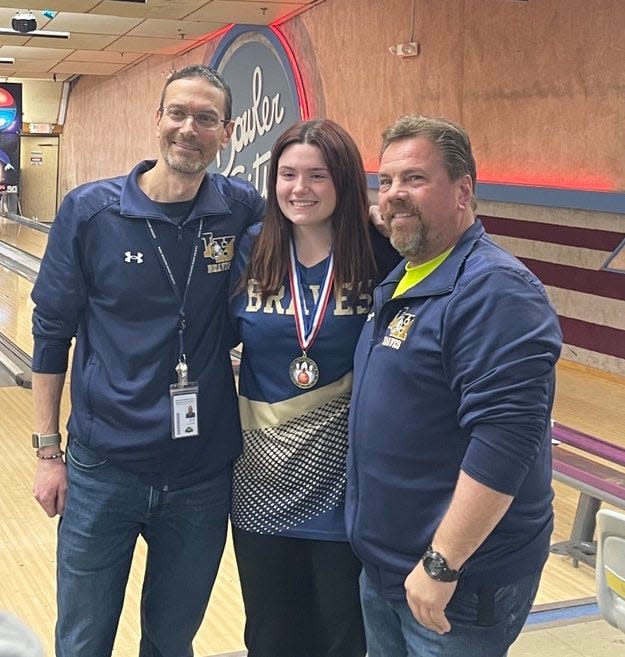 Indian Hills senior Natalie Christopher with coaches Mike Michels (left) and Jason Duncan after winning the championship at the Feb. 13 Bergen County girls bowling individual tournament at Bowler City in Hackensack.