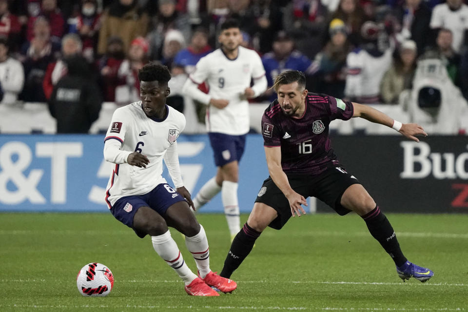 U.S. midfielder Yunus Musah (6) dribbles past Mexico midfielder Hector Herrera (16) during the first half of a FIFA World Cup qualifying soccer match Friday, Nov. 12, 2021, in Cincinnati. (AP Photo/Jeff Dean)