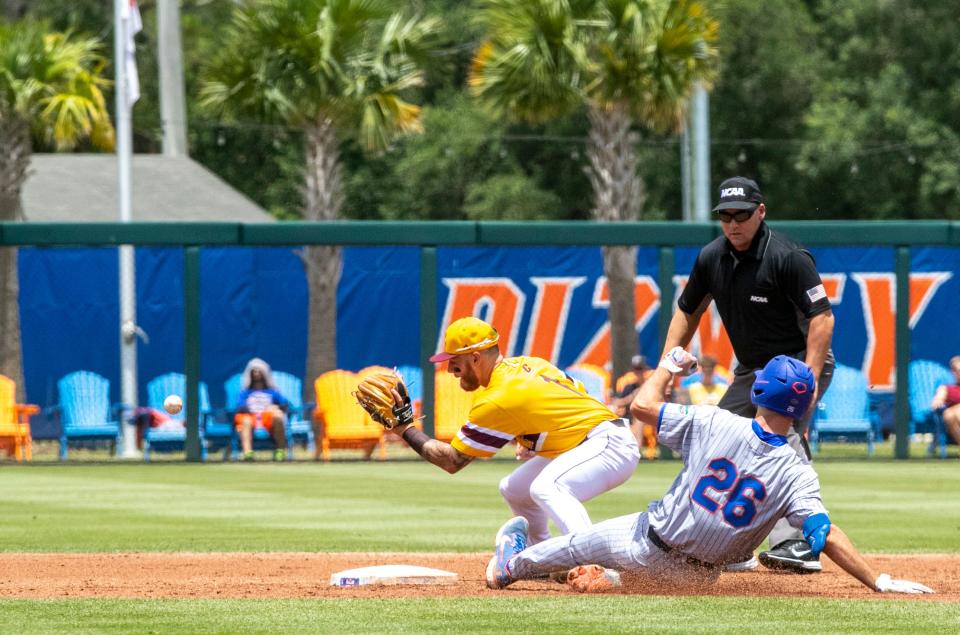 Florida's Sterlin Thompson (26) slides into second base under a tag by Central Michigan in the top of the third inning during an NCAA college baseball tournament regional game Sunday, June 5, 2022, in Gainesville, Fla.