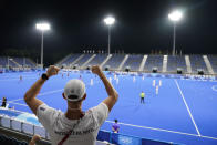 A member of the New Zealand delegation cheers for his team from stands empty of fans due to COVID-19 restrictions during a men's field hockey match against Spain at the 2020 Summer Olympics, Sunday, July 25, 2021, in Tokyo, Japan. (AP Photo/John Minchillo)