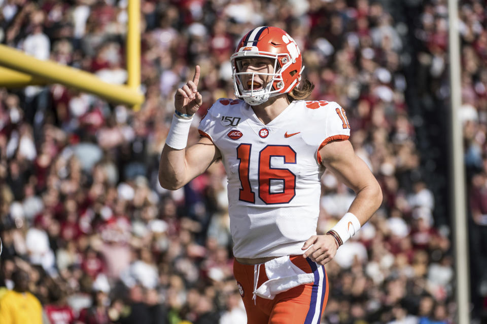 Clemson quarterback Trevor Lawrence (16) celebrates the a touchdown against South Carolina during the first half of an NCAA college football game Saturday, Nov. 30, 2019, in Columbia, S.C. (AP Photo/Sean Rayford)