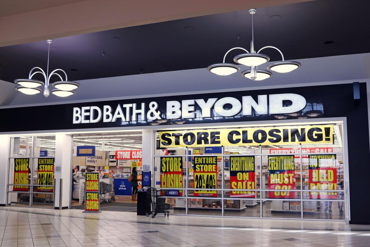 A Bed Bath & Beyond storefront with store closing signs advertising significant sales