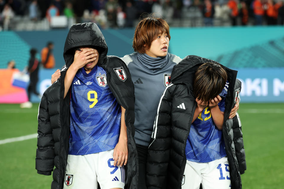 Reiko Yuki, Aoba Fujino is comforted by teammate Momoko Tanaka after losing in the quarterfinals to Sweden.  (Alex Grimm - FIFA/FIFA via Getty Images)