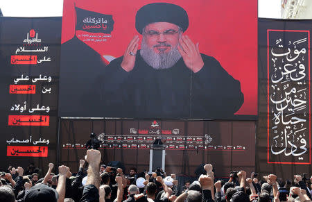 Lebanon's Hezbollah leader Sayyed Hassan Nasrallah gestures as he addresses his supporters via a screen during last day of Ashura, in Beirut, Lebanon September 20, 2018. REUTERS/Aziz Taher