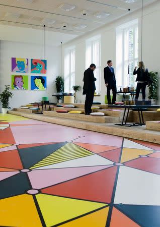 People stand in a show room loft of the Metropolis Park in Berlin June 26, 2014. REUTERS/Thomas Peter