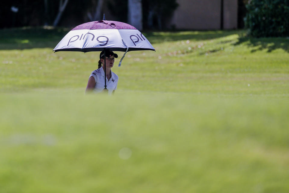 Emilia Carolina Migliaccio walks with an umbrella on the 12th hole during the first round of the ANA Inspiration golf tournament at Mission Hills Country Club in Rancho Mirage, Calif. Thursday, Sept. 10, 2020. (AP Photo/Ringo H.W. Chiu)