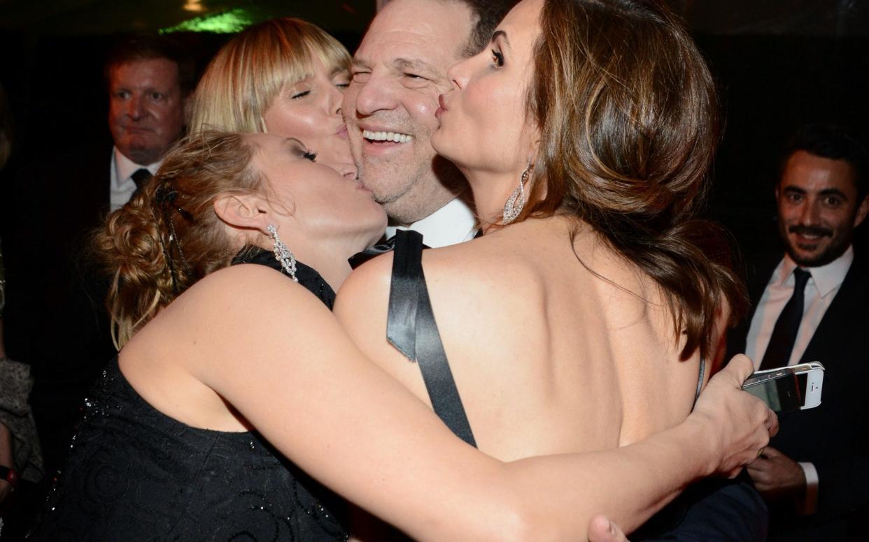Harvey Weinstein with Heidi Klum and Uma Thurman at a 2014 Golden Globes afterparty - Getty Images North America