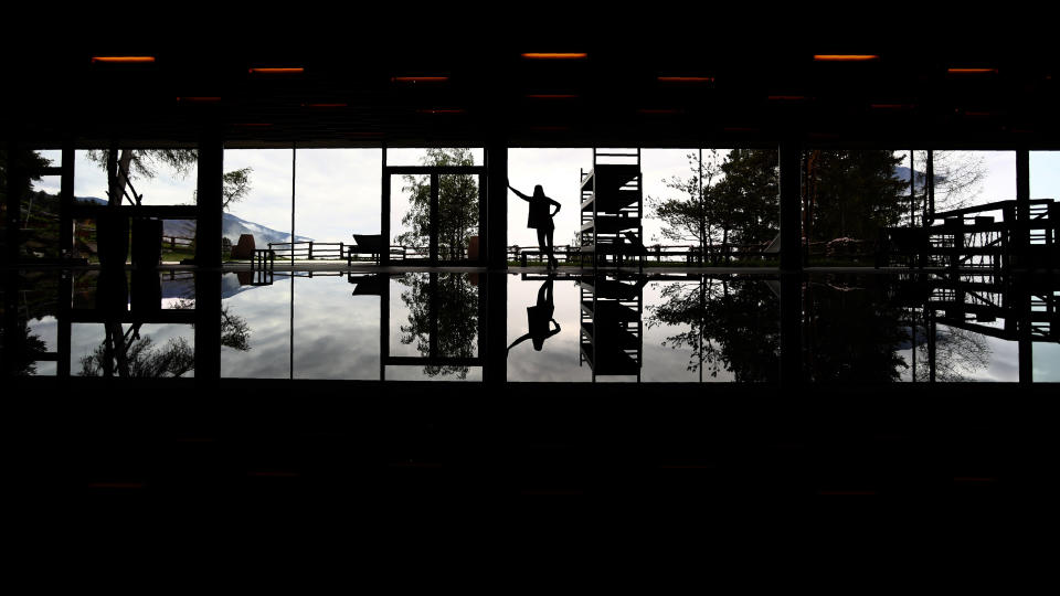 In this picture taken on Wednesday, May 13, 2020 spa chef Magdalena Blasbichler poses at the indoor pool of the My Arbor wellness hotel in Bressanone, Italy. Italy opens its borders to foreign tourists on June 3 in a bid to salvage the summer tourism season -- but for hotel owners there are still many unknowns before deciding to open their doors. My Arbor, a wood-clad four-start hotel overlooking the northernmost city of Bressanone, was forced with all the other hotels in Italy’s German-speaking South Tyrol region to close on March 11. (AP Photo/Matthias Schrader)