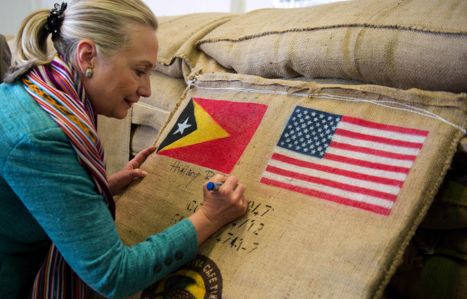 U.S. Secretary of State Hillary Rodham Clinton autographs a coffee bean sack while visiting the Timor Coffee Cooperative in Dili, East Timor Thursday, Sept. 6, 2012. U.S. Secretary of State Hillary Rodham Clinton is in East Timor to offer the small half-island nation support as it ends its reliance on international peacekeepers. (AP Photo/Jim Watson, Pool)