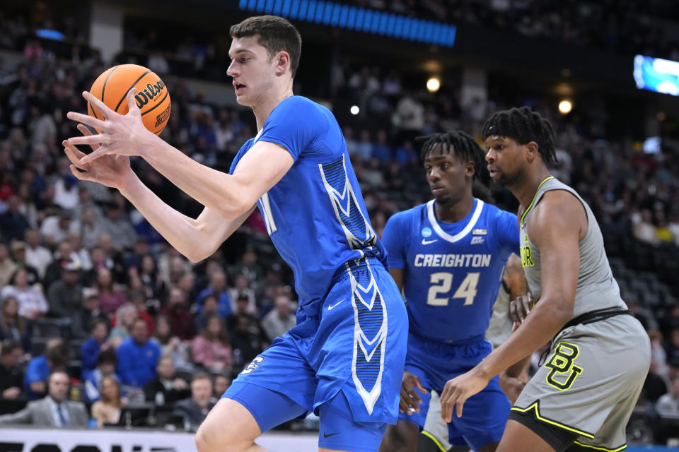 Creighton center Ryan Kalkbrenner, left, pulls in a rebound in front of forward Arthur Kaluma, center, and Baylor forward Flo Thamba during the first half of a second-round college basketball game in the men's NCAA Tournament on Sunday, March 19, 2023, in Denver. (AP Photo/David Zalubowski)