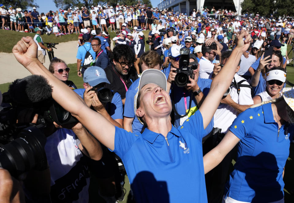 Members of the Europe team and supporters celebrate at the end of the match between Europe's Carlota Ciganda and United States' Nelly Korda at the Solheim Cup golf tournament in Finca Cortesin, near Casares, southern Spain, Sunday, Sept. 24, 2023. Europe has beaten the United States during this biannual women's golf tournament, which played alternately in Europe and the United States. (AP Photo/Bernat Armangue)