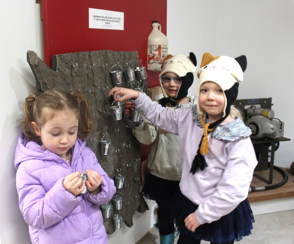 From left, Ambree Whaley of Markleton and sisters Adeline and Alivia Hay of Somerset learned how many gallons of sap it takes to make one gallon of maple syrup at a learning station at the Pa. Maple Museum during the Maple Tour this past weekend. The tour is open again this weekend at 23 different sites.