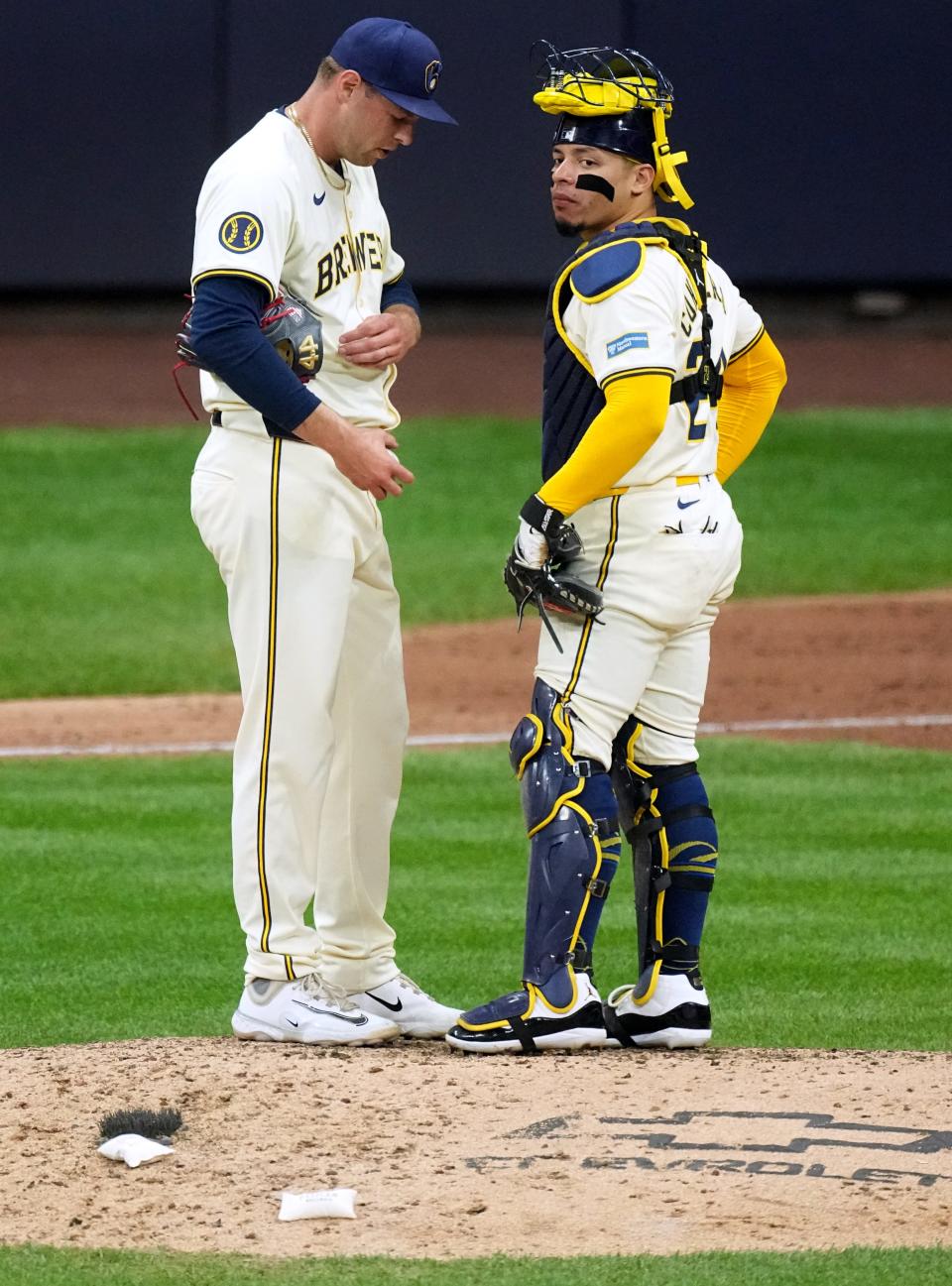 Brewers pitcher Trevor Megill and catcher William Contreras talk during the ninth inning.