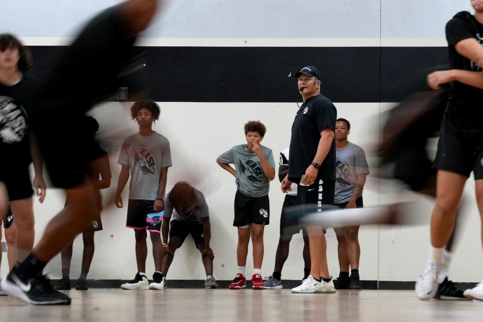 Lakota East head football coach Jon Kitna observes play during practice in the school’s gymnasium Monday.