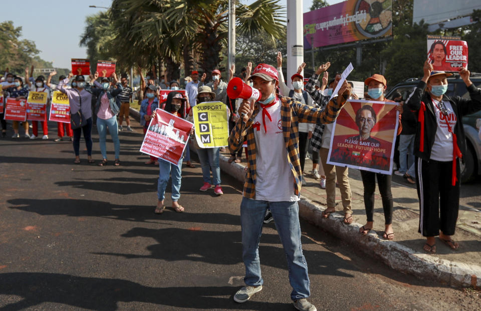 Demonstrators display placards with pictures of deposed Myanmar leader Aung San Suu Kyi to protest against the military coup in Yangon, Myanmar, Wednesday, Feb. 17, 2021. The U.N. expert on human rights in Myanmar warned of the prospect for major violence as demonstrators gather again Wednesday to protest the military's seizure of power. (AP Photo)