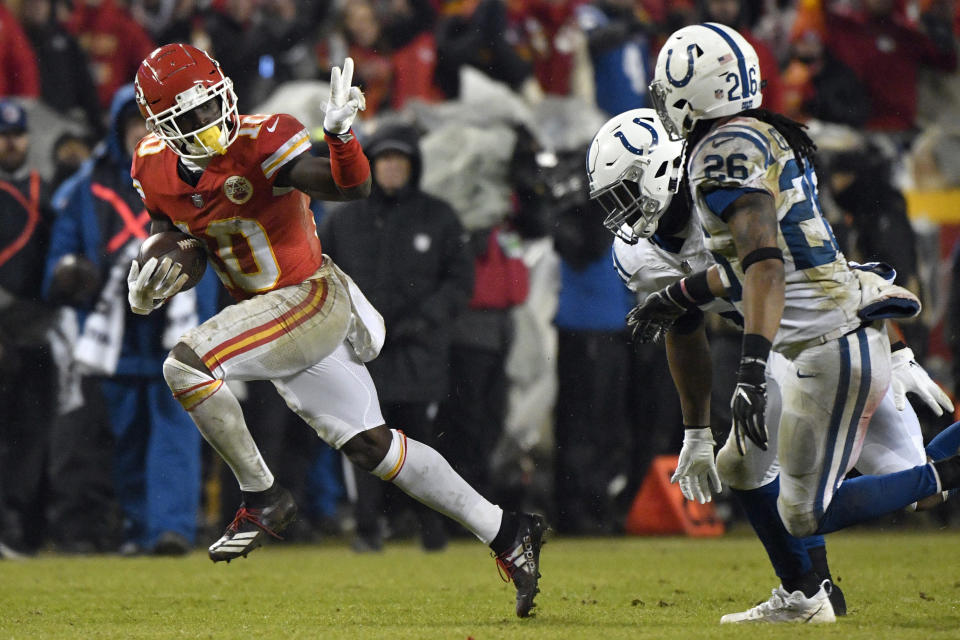 Kansas City Chiefs wide receiver Tyreek Hill (10) gestures as he runs past Indianapolis Colts safety Clayton Geathers (26) and linebacker Anthony Walker during the second half of an NFL divisional football playoff game in Kansas City, Mo., Saturday, Jan. 12, 2019. (AP Photo/Ed Zurga)
