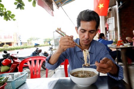 Vietnamese deportee and Amerasian Pham Chi Cuong, 47, who was deported from U.S., eats along a street in central Ho Chi Minh City, Vietnam April 20, 2018, REUTERS/Kham