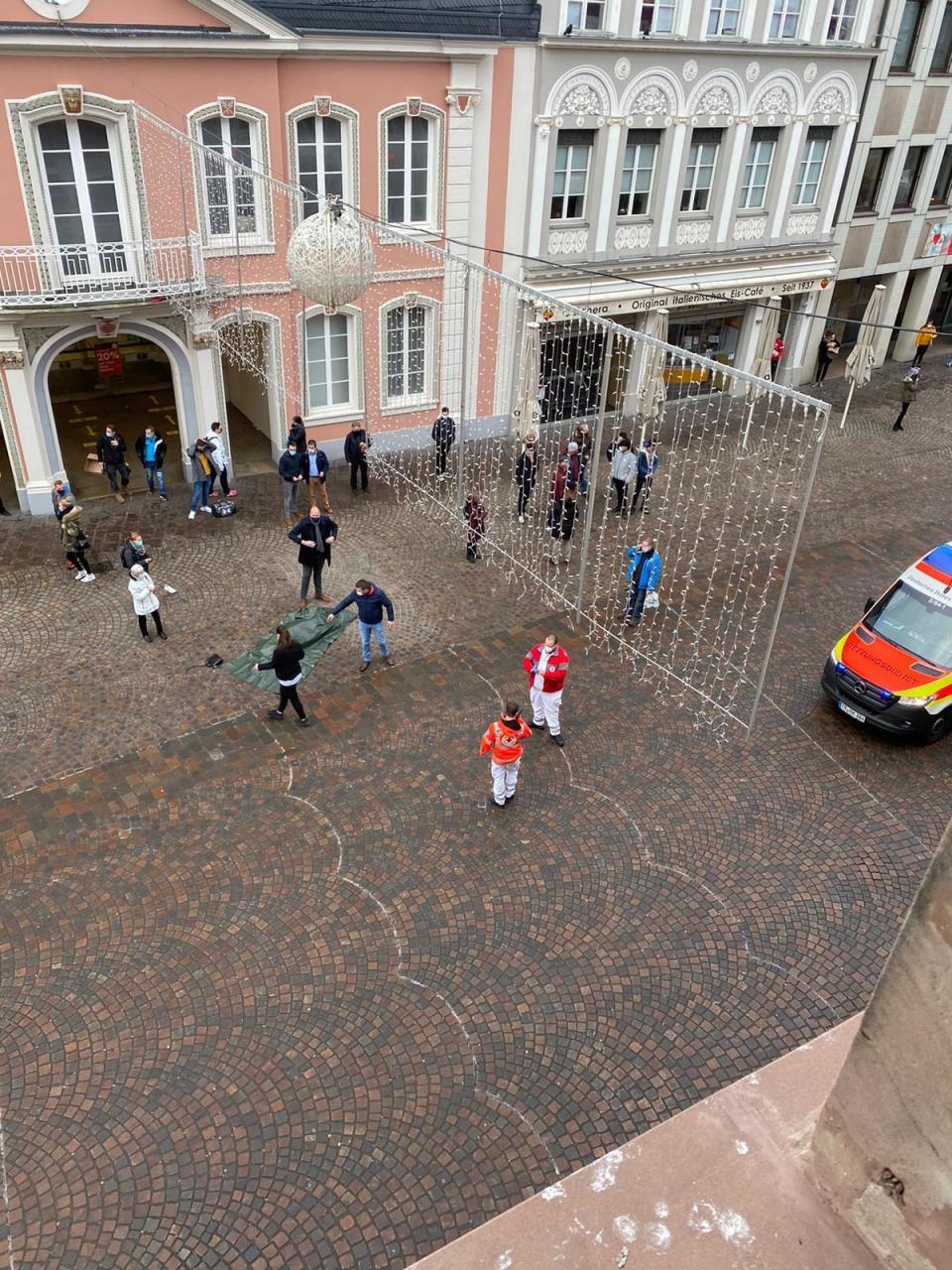 Rescue workers are pictured in the city of Trier, Germany, Tuesday, Dec 1, 2020. German police say two people have been killed and several others injured in the southwestern German city of Trier when a car drove into a pedestrian zone. Trier police tweeted that the driver had been arrested and the vehicle impounded. (AP Photo/Sebastian Schmitz, lokalo.de)