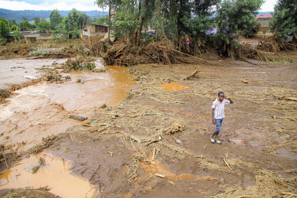 A child walk through an area swept away after a dam burst in Kamuchiri Village Mai Mahiu, Nakuru County, Kenya, Monday, April. 29, 2024. Kenya's Interior Ministry says at least 45 people have died and dozens are missing after a dam collapsed following heavy rains. (AP Photo/Patrick Ngugi)