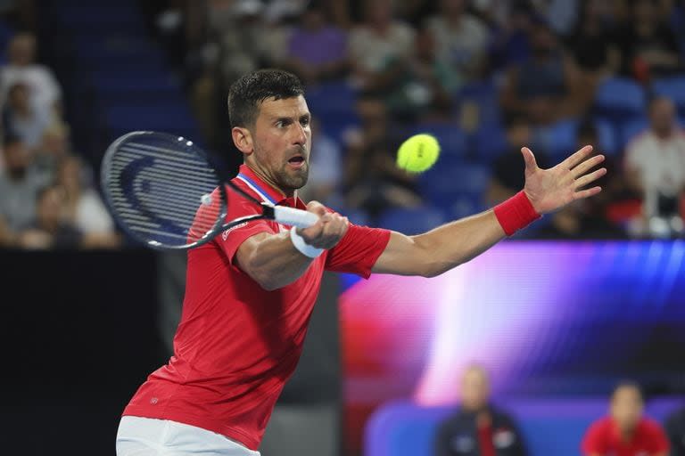 Novak Djokovic of Serbia plays a return shot to Zhizhen Zhang of China during the United Cup tennis tournament in Perth, Australia, Sunday, Dec. 31, 2023. (AP Photo/Trevor Collens)