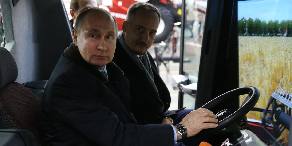 Russian President Vladimir Putin (L) examines a tractor simulator while visiting a tractor plant of Rostselmash, in Rostov-on-Don, 1060 km. south of Moscow, Russia, February 1, 2018.