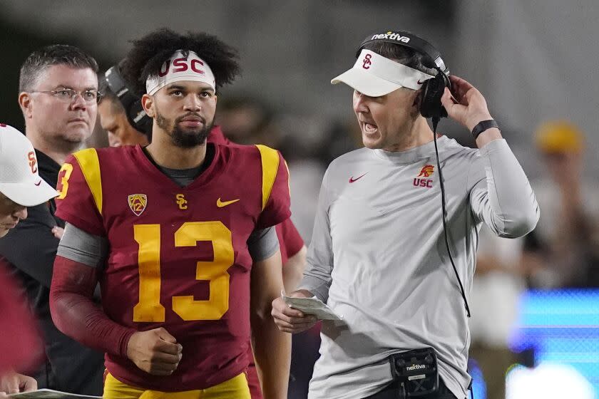 Southern California quarterback Caleb Williams, left, talks with head coach Lincoln Riley