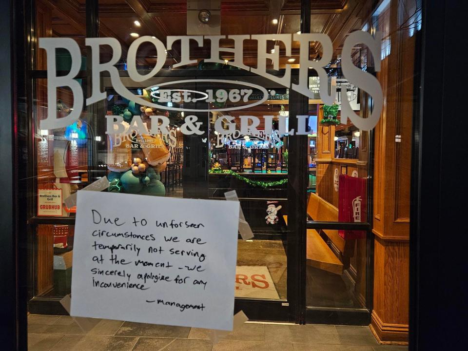 A sign on the door of Brothers Bar & Grill at Newport on the Levee states the restaurant was closed for "unforeseen circumstances" on Saturday night.