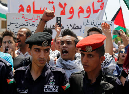 Protestors chant slogans during a demonstration near the Israeli embassy in Amman, Jordan July 28, 2017. The banner reads, "Resist don't submit". REUTERS/Muhammad Hamed