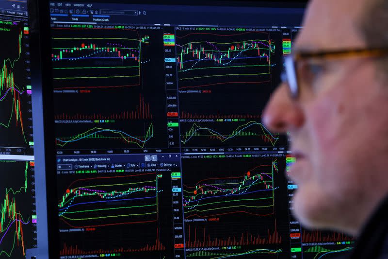 Traders work on the floor of the NYSE in New York