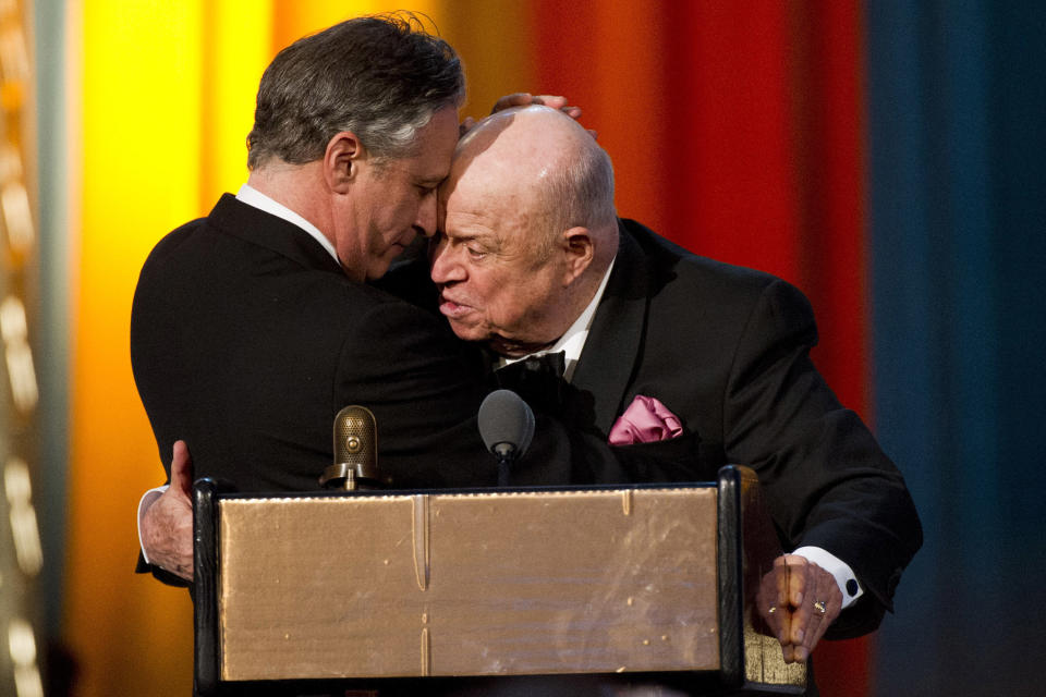 Jon Stewart, left, presents Don Rickles with the Johnny Carson Award at The 2012 Comedy Awards in New York, Saturday, April 28, 2012. (AP Photo/Charles Sykes)