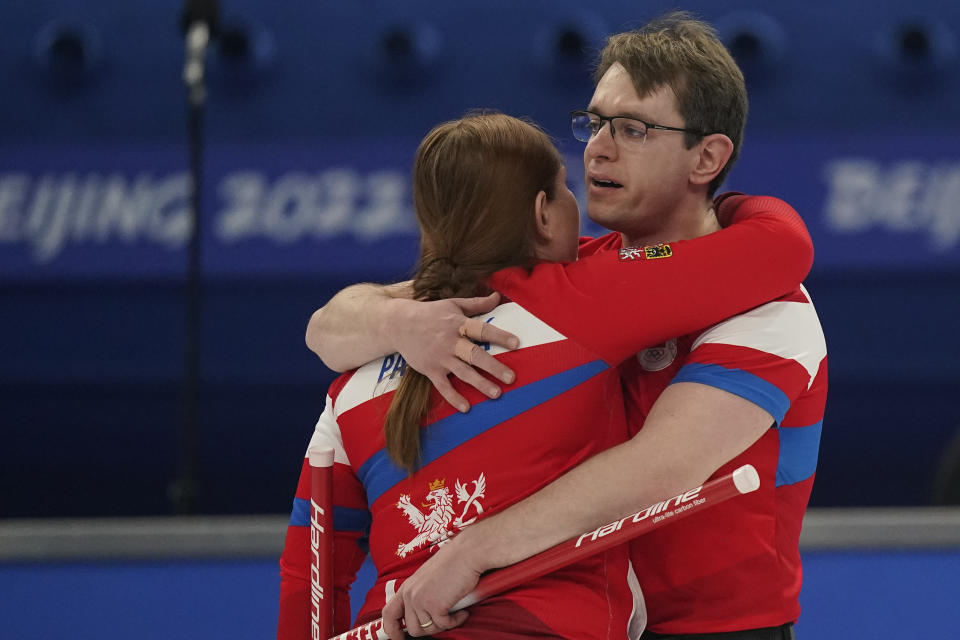 Tomas Paul, right, of the Czech Republic, celebrates a win with teammate Zuzana Paulova, left, after the mixed doubles curling match against China at the Beijing Winter Olympics Monday, Feb. 7, 2022, in Beijing. (AP Photo/Brynn Anderson)