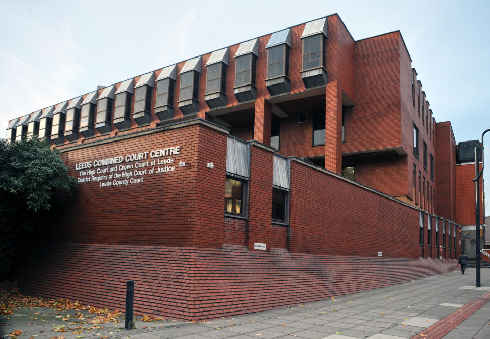 Leeds, England - January 18, 2018: man walking past the entrance to leeds combined magistrates and crown court building