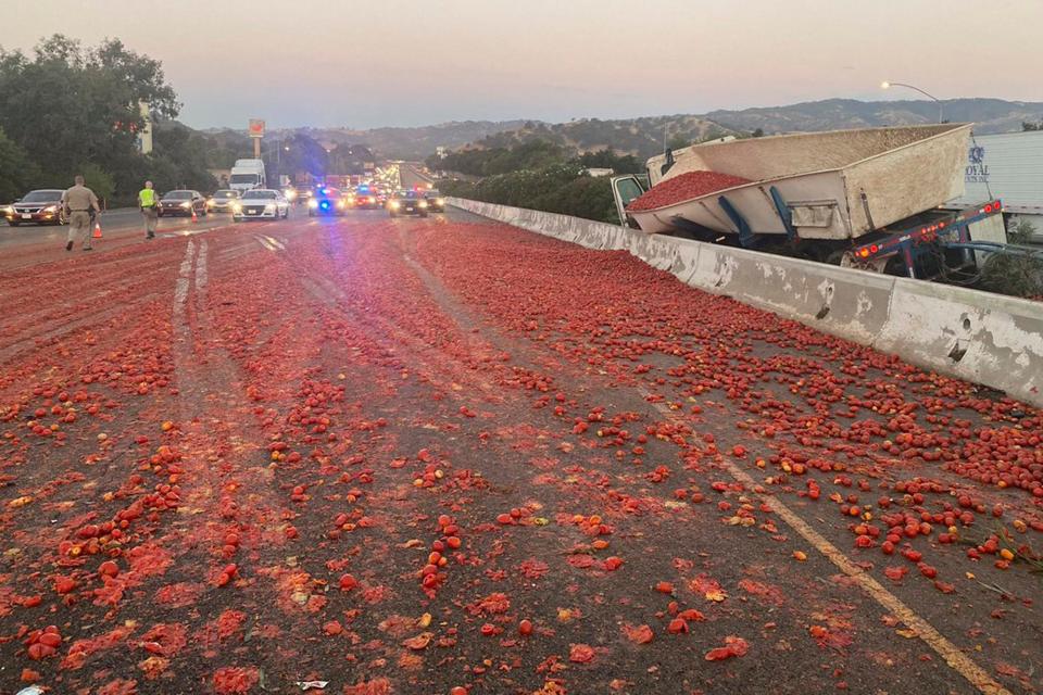 In this photo provided by the California Highway Patrol is the scene where a truck hauling a load of the tomatoes crashed after a collision near Vacaville, Calif., Monday, Aug. 29, 2022.