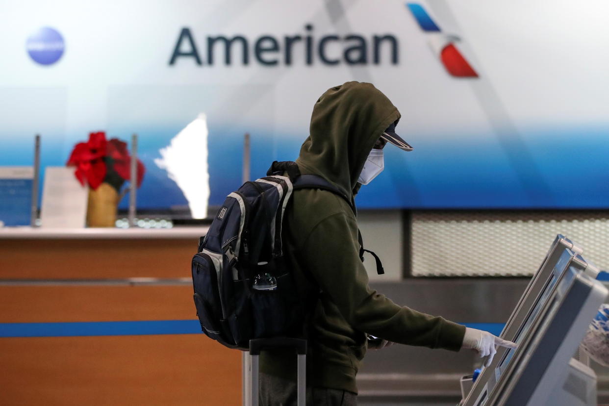 A traveler checks-in for a flight at O'Hare International Airport ahead of the Thanksgiving holiday during the coronavirus disease (COVID-19) pandemic, in Chicago, Illinois, U.S. November 25, 2020. REUTERS/Kamil Krzaczynski