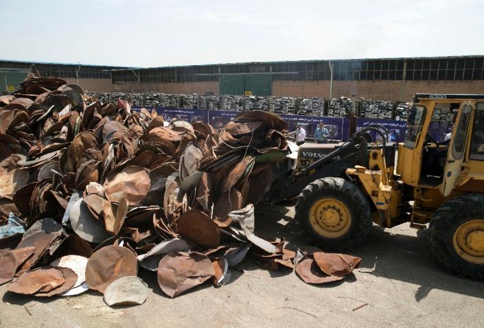 Satellite dishes and receivers being piled up before being destroyed during a ceremony in the Iranian capital Tehran on July 24, 2016 (AFP Photo/Hoseein Zohrevand)