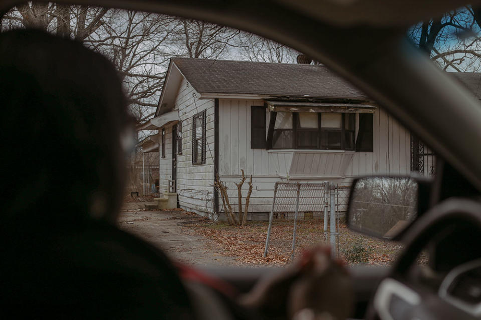 TyKesha Cross looks on at her grandparent’s old home, where she spent much of her childhood. All around Pine Bluff, decaying homes and businesses stand as stark reminders of its past and current economic challenges and population decline. But local educators and leaders feel a new era of revitalization has begun. (Marianna McMurdock/The 74)