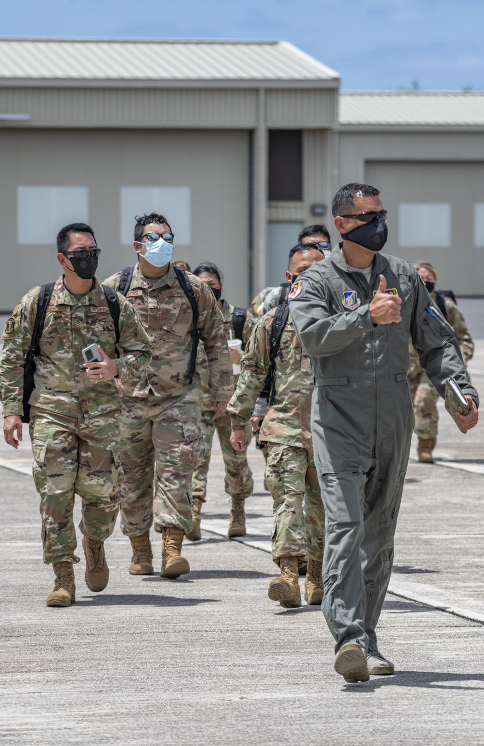 In this April 17, 2020, photo provided by the Hawaii National Guard, is Lt. Col. Kai Kahele, right, leading a group of soldiers and airmen at Kalaeloa Airfield in Kapolei, Hawaii. Kahele is the only major candidate in the race to succeed U.S. Rep. Tulsi Gabbard, virtually guaranteeing he will be sworn in as Hawaii's newest congressman in January. (Sgt. John Schoebel/Hawaii National Guard via AP)