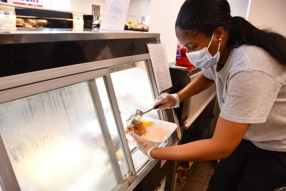 Line cook Janasia Sneed prepares healthy, hot deli foods and breakfast meals to go at the Evans Center and market, a vital hub to a low- to moderate-income area in Melbourne and Palm Bay.