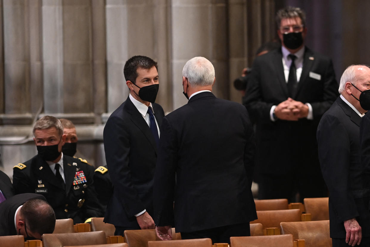 Former US Vice President Mike Pence (C) speaks with Transportation Secretary Pete Buttigieg at the Washington National Cathedral before the funeral service of former US Senator Bob Dole, on December 10, 2021, in Washington, DC. (Photo by Brendan SMIALOWSKI / AFP) (Photo by BRENDAN SMIALOWSKI/AFP via Getty Images)