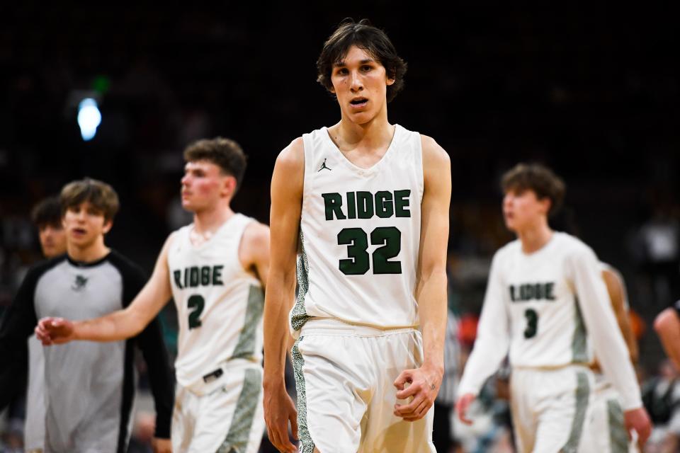 Fossil Ridge boys basketball player Nick Randall (32) gets back on defense after a timeout during the 6A state championship against Denver East at the Denver Coliseum on Saturday, March 11, 2023, in Denver, Colo. The SaberCats lost 82-61.